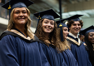 MRU graduates wearing gowns and caps celebrate their achievement at Convocation 2025.
