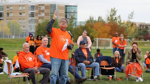 A group of people wearing orange shirts at the human spiderweb