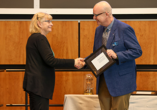 Retiree Cindy Hamonic receives congratulations from Mount Royal President and Vice-Chancellor Tim Rahilly, PhD, at the Long Service and Retirement Brunch.