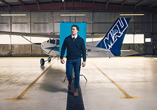 Sid Nichol walks by a plane at the MRU Springbank Hangar.